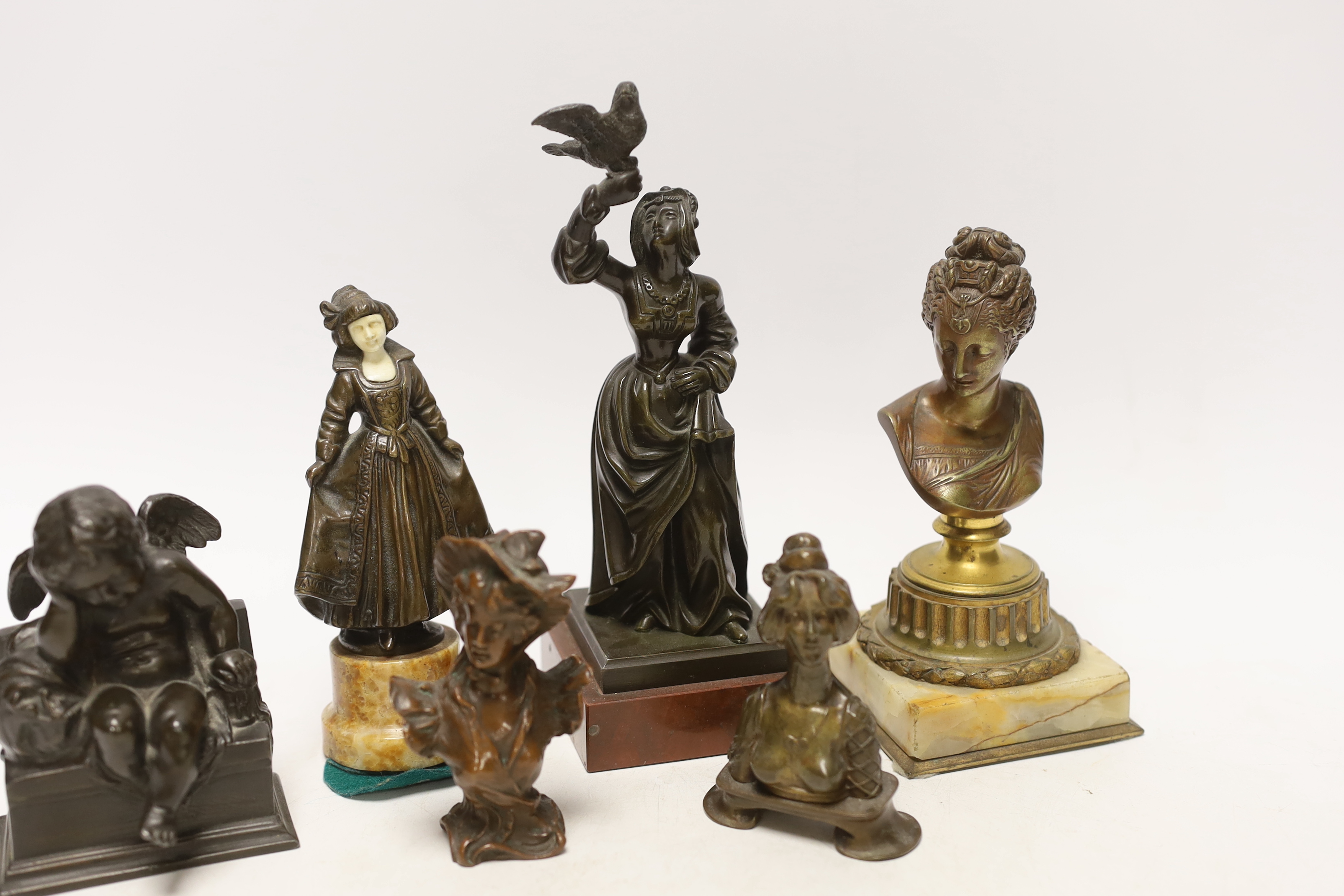 Two bronze figures, one bone mounted, three bronze busts and a patinated spelter figure of Cupid, 19th/early 20th century, 20cm high